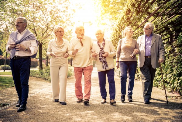 old people walking in the park sunny happy medical alert systems